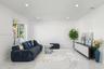 Neutral-toned interior featuring large-format tile flooring, recessed lighting, and a wide sliding glass door