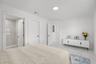 Room featuring white-finish tile flooring with gray veining, flush-mount lighting, and an enclosed shower stall with floor-to-ceiling veined tile wall