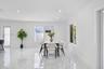 Open-concept interior featuring large-format polished stone-finish floor tiles, recessed ceiling lighting, and multiple windows