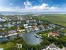 The property can accommodate an approximately 100-foot yacht, while the wide bay beyond provides the maneuvering room a vessel of this scale requires.