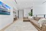 Open-concept space featuring wood-finish flooring, recessed lighting, built-in desk cabinetry, and a metal-rail staircase