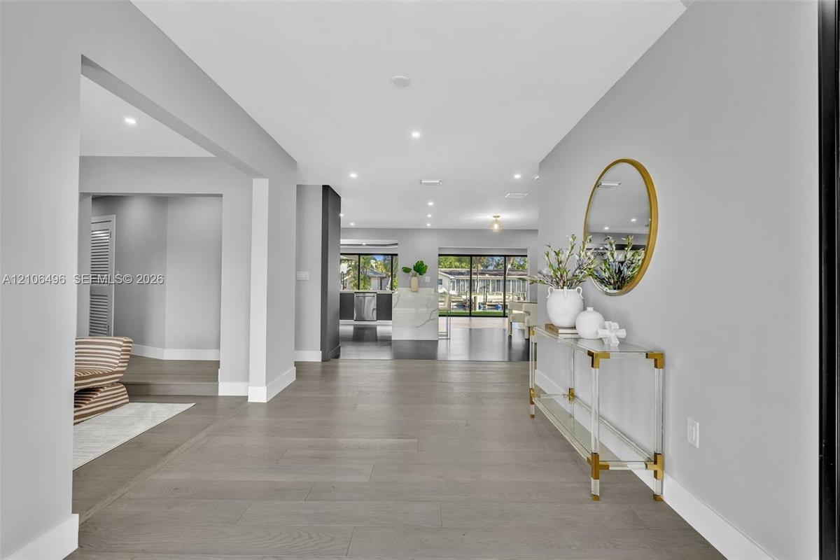 Open floor plan featuring wood-finish flooring, recessed lighting, and large sliding glass doors