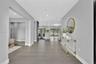 Open floor plan featuring wood-finish flooring, recessed lighting, and large sliding glass doors
