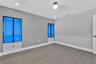 Wood-finish flooring, neutral wall tones, recessed lighting, and built-in cabinetry featuring illuminated glass-panel doors and integrated drawers