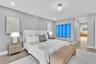Neutral wall tones, wood-finish flooring, recessed lighting, and built-in glass-paneled cabinetry
