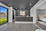 Built-in wet bar featuring a fluted front, stone countertop, recessed lighting, and a dark-toned accent wall