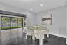 Large-format sliding glass doors, polished concrete flooring, recessed lighting, and water-front exterior exposure