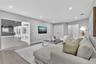 Neutral-toned living space featuring wood-finish flooring, recessed lighting, and double-door closet storage