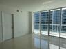 Floor-to-ceiling glass paneling and polished tile flooring