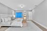 Neutral interior space featuring wood-finish flooring, recessed lighting, and a globe-style ceiling fixture