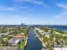 Aerial perspective of waterfront properties featuring direct canal access, private docks, and tropical landscaping