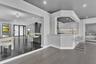 Open-concept kitchen featuring flat-panel cabinetry, a peninsula with stone-finish countertops, recessed lighting, and wood-finish flooring