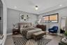 Neutral-toned bedroom featuring wood-finish flooring, recessed lighting, and a single-globe ceiling fixture