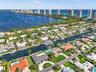 Waterfront aerial perspective featuring direct canal access, private boat dockage, and coastal scenery