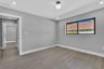 Interior space featuring wood-finish flooring, neutral wall paint, recessed lighting, a globe-style light fixture, and a black-framed window