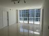 Floor-to-ceiling glass windows, polished tile flooring, and multi-directional track lighting