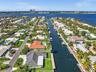Waterfront canal location featuring direct deep-water access, fixed dock infrastructure, and a landscaped backyard