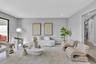 Neutral interior space featuring wood-finish flooring, recessed lighting, and a large floor-to-ceiling glass panel door