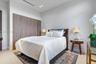 Floor-to-ceiling wood-finish cabinetry, neutral large-format tile flooring, recessed ceiling lighting, and clean-lined interior finishes
