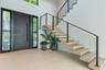 Foyer featuring a large-format tile floor, a solid front door with floor-to-ceiling sidelights, and an open-riser staircase with wood-finish treads an