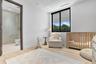 Light-filled room featuring wood-finish flooring, recessed lighting, and a window with a black frame