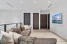 Interior space featuring recessed lighting, wood-finish flooring, metal cable railing, and solid-core dark wood doors