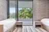 Floor-to-ceiling sliding glass door, private balcony with metal railing, and textured wall coverings