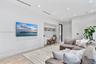 Room featuring wood-finish flooring, recessed lighting, linear HVAC diffusers, and built-in workstation with overhead cabinetry
