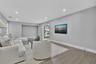 Living area featuring recessed lighting, neutral wall paint, wood-finish flooring, and a recessed wall niche