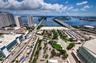 Aerial perspective showcasing high-density urban infrastructure, expansive waterfront proximity, multi-lane causeway systems, and integrated public tr