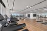 Fitness center featuring floor-to-ceiling windows, wood-finish flooring, full-wall mirrors, and recessed ceiling lighting