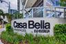 Architectural monument sign featuring dimensional lettering, manicured landscaping with ground cover, and glass-panel railing