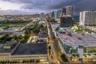 Aerial perspective of an urban setting featuring high-rise architecture, concentrated commercial developments, metropolitan thoroughfares, and proximi