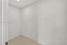 Neutral-toned interior space featuring smooth wall surfaces and large-format tile flooring