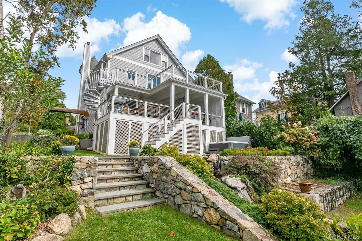 Luxury living with koi pond, hot tub and two tier decking. Please note whimsical canoe archway entrance.