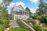 Luxury living with koi pond, hot tub and two tier decking. Please note whimsical canoe archway entrance.