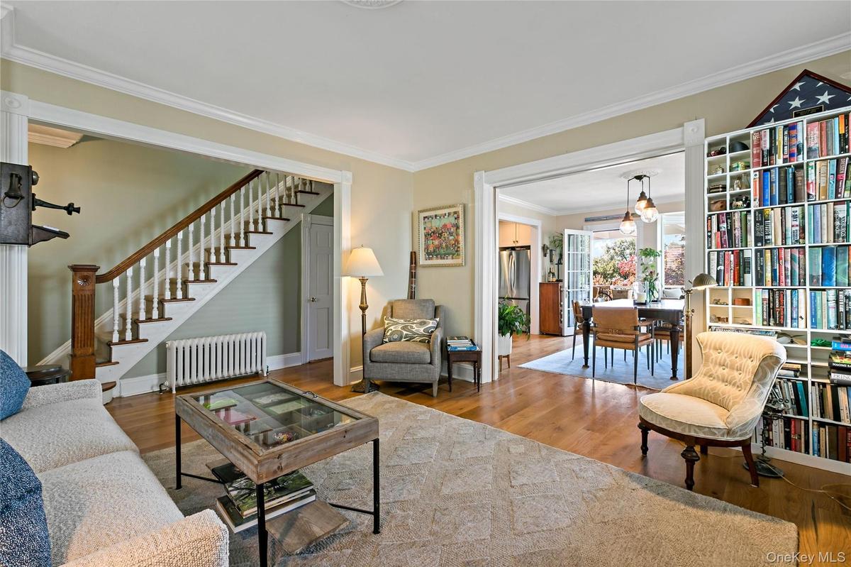 Another angle of living room showing enormous glass pocket doors open to formal dining room.