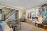 Another angle of living room showing enormous glass pocket doors open to formal dining room.