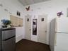 Kitchen with freestanding refrigerator, a paneled ceiling, and dark carpet