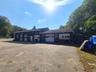 Garage featuring asphalt driveway