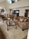 High ceilings with an upper-level balcony, a formal dining area, and a kitchen with a breakfast bar