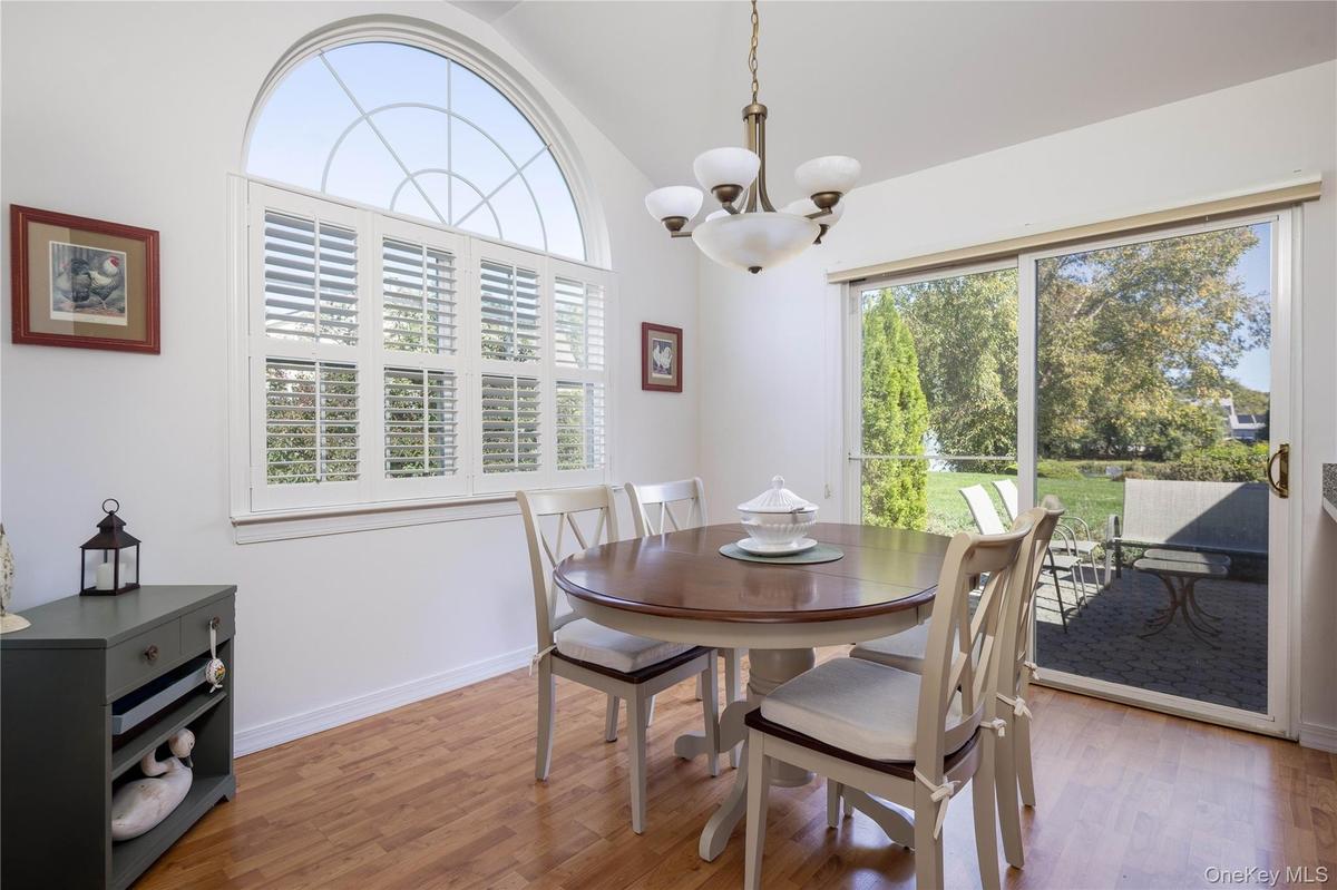 Dining Room Open to Kitchen and Living Room. Glass Sliders to the Patio