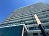 Modern high-rise architecture featuring tiered balconies, glass and metal railings, and a multi-story glass facade