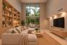 Double-height ceiling featuring expansive floor-to-ceiling windows, custom built-in light-tone wood shelving with integrated task lighting, and a wall
