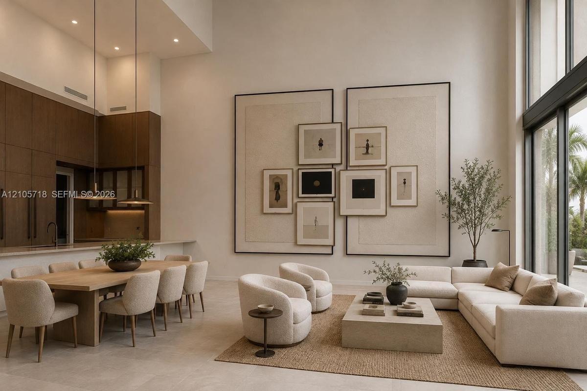 Double-height ceilings, floor-to-ceiling windows, custom built-in wall paneling, full-height dark wood-finish cabinetry, and neutral stone-finish floo