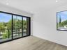 Room featuring wood-finish flooring, recessed lighting, expansive sliding glass doors, a private balcony with a metal railing, and large windows