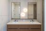 Master bath Double vanity with a textured wood-finish cabinet, stone-finish countertop, dual rectangular undermount sinks, bronze-finish widespread fa