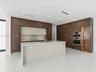 Modern kitchen featuring full-height wood-finish cabinetry, a waterfall-edge stone island, built-in stainless steel double ovens, and a glass-front di