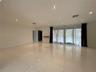 Polished tile flooring, recessed ceiling lighting, and expansive floor-to-ceiling glass sliding doors