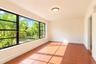 Floor-to-ceiling windows with black frames, tile flooring, and flush-mount ceiling lighting